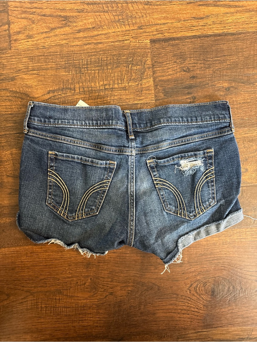 Hollister low-rise distressed denim shortie shorts in a medium wash size 15